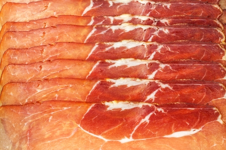 Thinly sliced ??German black forest ham with sliced ??ciabatta bread. Sliced ??and smoked ham with ham or prosciutto. Traditional German foodの写真素材