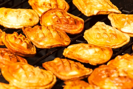 Oscypek - traditional smoked cheese made of salted sheep on a grill. Traditional Polish smoked...