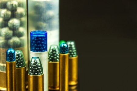Shotgun shell cartridge on black background. Detail of shotgun munitions. Sale of weapons and ammunition. Hunting seasonの写真素材