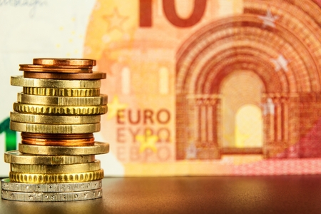 Euro coins on euro banknotes as background. Close-up of several euro coins. Concept of trading on the stock exchange. Euro exchange rateの写真素材