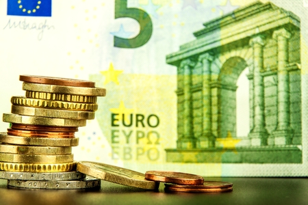 Euro coins on euro banknotes as background. Close-up of several euro coins. Concept of trading on the stock exchange. Euro exchange rateの写真素材