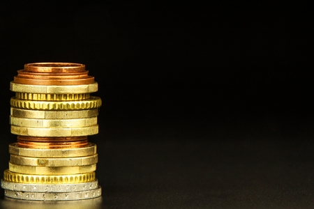 Euro coins on black background. Close-up of several euro coins. Concept of trading on the stock exchange. Euro exchange rateの写真素材