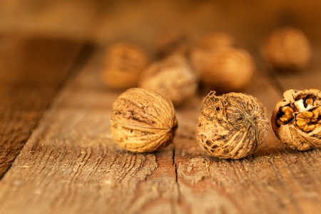 Walnuts on a wooden table. Healthy Nuts. Blurred background. Vegetarian food