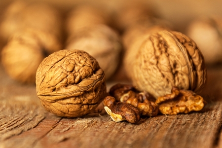 Walnuts on a wooden table. Healthy Nuts. Blurred background. Vegetarian food