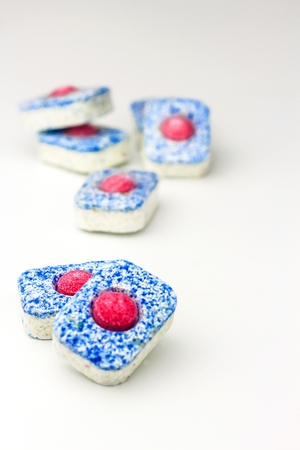 Dishwasher tablets on white background. Organic dishwasher. Detail of cleaner. Chemical industry