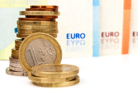 Euro coins and banknotes on a white background. Exchange rate. Stock market trading. The common European currency.の写真素材