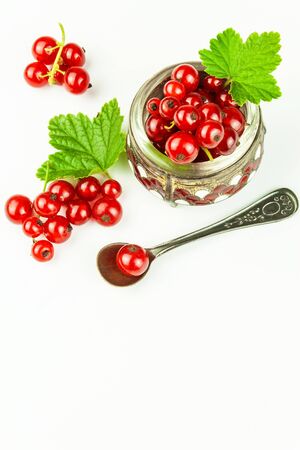 Fresh red currant berries on a white background. Red currant in bowl with green leaf. Healthy food.の写真素材