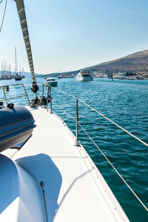 Boats on the Adriatic Sea from the deck of a yacht. Cruise from harbor Trogir - Croatia. Sailing on a yacht. Holiday in Croatia. Transport at sea.の写真素材