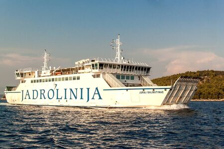 BRAC, CROATIA - August 31, 2019: Ferry Jadrolinija near Brac island in Croatia. Evening cruise to the port of Split. View from yacht.のeditorial素材