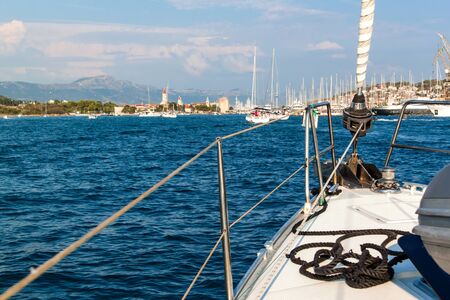 Sailboat sails to the port of Trogir in Croatia. View from deck of sailboat. Historic town on the...