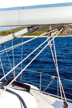 Close-up view of sailboat ropes. Pulleys and ropes on the mast. Yachting sport. Ship equipment.