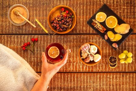 Cup of herbal tea on wooden background. Traditional medicine, flu  concept. Rosehip tea against cold and flu. Treatment of influenza.. Flu epidemic.の写真素材