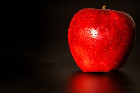 Apple with water drops on black background. Growing fruits. Close-up of apples. Fresh fruit. Healthy...
