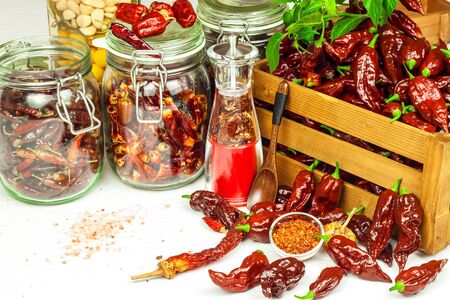 Harvest or chilli. Chili (Bhut Jolokia Chocolate) in a wooden crate. Preparation for drying. Spicy food. Sale of spices.の写真素材