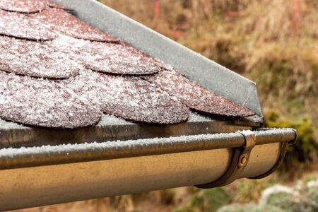 Frost on the roof of the terrace. Ice roof coating. Cold weather. Ice crystals on the roof covering.