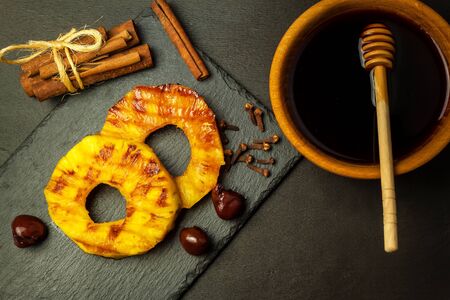 Grilled pineapple with pickled cherries. Homemade barbecue. Summer refreshment. Pineapple on the grill.の写真素材