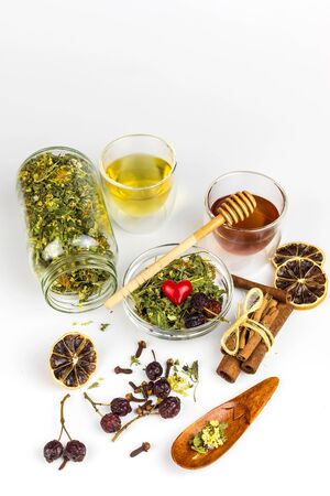 Medicinal herbal tea with honey on white background. Traditional treatment of flu and cold. Alternative medicine. Medicinal herbs.の写真素材
