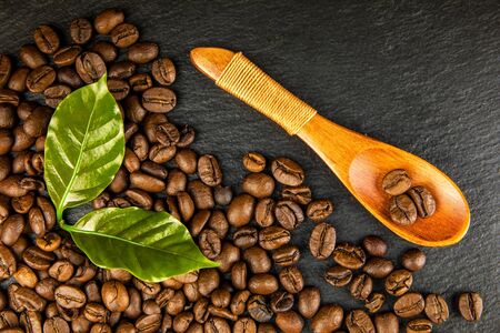 Coffee beans on slate plate. Growing coffee. Fresh coffee beans. Traditional hot drink. Fair trade.の写真素材