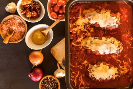 Baked chicken breast with bacon and cheese in tomato sauce. Healthy food. Home cooking