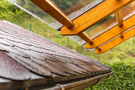 Rainy day. Roof in the rain. Polycarbonate Roofing use for house decoration. Transparent roof with wooden beams. の写真素材