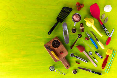 Kitchen utensils on a wooden background. Various kitchen utensils on wooden table. Chef tools. Home cooking.の写真素材