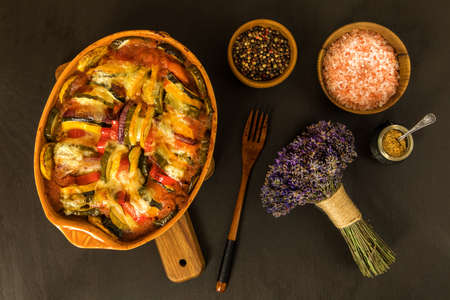 ratatouille vegetarian dish, baked vegetables. Diet vegetable food. Traditional french baked ratatouille on black background.の写真素材