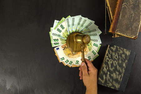 Money and judges hammer on wooden table. Representation of corruption and bribery in the judiciary....