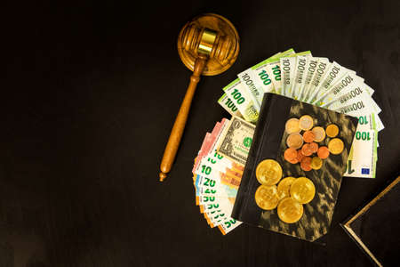 Money and judges hammer on wooden table. Representation of corruption and bribery in the judiciary....