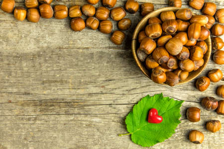 hazelnuts on wooden table, top view. Food background. Heap of many whole ripe brown hazel nuts. Vegan food.の写真素材