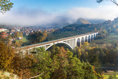 Railway bridge in autumn in the Czech Republic of the village Dolni Loucky. Train transport. Autumn foggy morning in the countryside.の写真素材