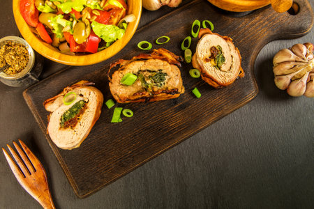Roast pork tenderloin stuffed with spinach and sun - dried tomatoes. Diet food. Home cooking. Pork tenderloin.の写真素材