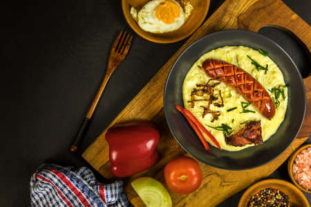 Pork sausages with mashed potato. Bangers and mash pork sausages and mashed potato. Unhealthy and greasy food. Grilled sausage.の写真素材