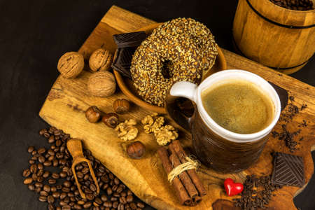 Yummy donuts with sprinkles on wooden table, flat lay. Donuts and coffee. Unhealthy food. Risk of obesity. Chocolate and coffee beans.の写真素材