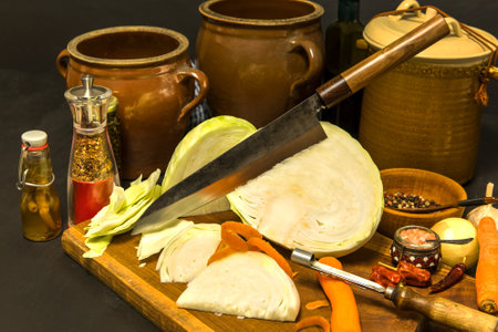 Marinated cabbage - Sauerkraut. Fresh cabbage prepared for pickling on woodboard. Ingredients for home-made vegetable canning in the kitchen.の写真素材