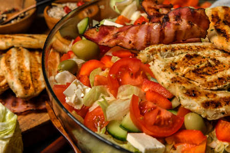 Vegetable salad with chicken and bacon. Salad with tomatoes and cheese. Diet food. Chicken steak with vegetables.の写真素材