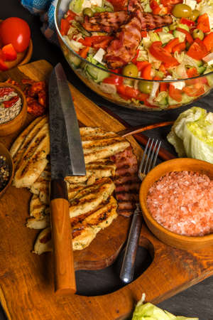 Vegetable salad with chicken and bacon. Salad with tomatoes and cheese. Diet food. Chicken steak with vegetables.の写真素材