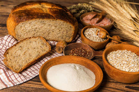 Fresh homemade rustic wholegrain bread. Homemade bread with sunflower seeds on the kitchen table. Traditional meal. Home baking.の写真素材