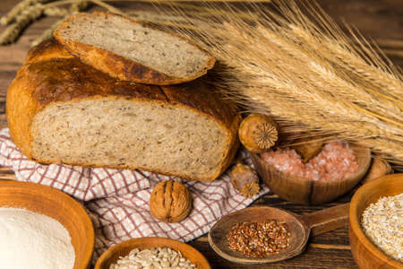 Fresh homemade rustic wholegrain bread. Homemade bread with sunflower seeds on the kitchen table. Traditional meal. Home baking.の写真素材
