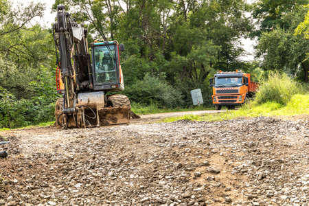 Repair of a road bridge in the Czech Republic near the village of Rikonin. Excavator on an empty construction site. Road repair.の写真素材