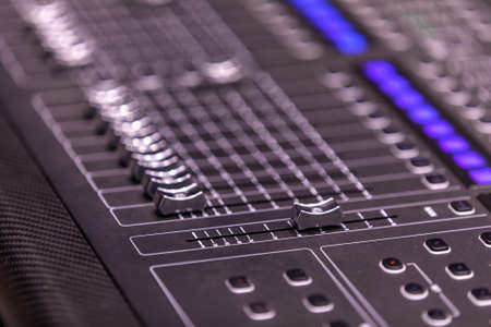 buttons equipment in audio recording studio. Professional concert mixing console is equipped with...