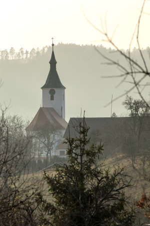 Foggy autumn day. View of the church in the village of Dolni Loucky in the Czech Republic. Church in the fog. Autumn fog in the countryside.の写真素材