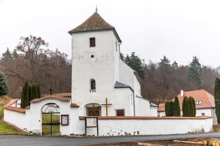 View of the gothic country church of St. Peter and Paul in the village of Zdarec. Country church in the Czech Republic - Europe. Foggy autumn day.の写真素材