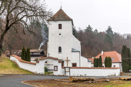View of the gothic country church of St. Peter and Paul in the village of Zdarec. Country church in the Czech Republic - Europe. Foggy autumn day.の写真素材