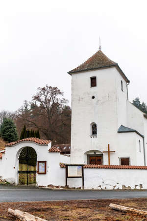 View of the gothic country church of St. Peter and Paul in the village of Zdarec. Country church in the Czech Republic - Europe. Foggy autumn day.の写真素材