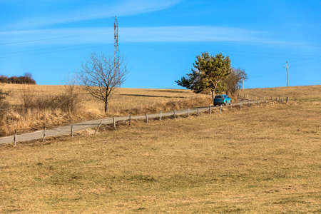 Car on a country road in the Czech Republic. Sunny day on vacation. Driving in the countryside.の写真素材
