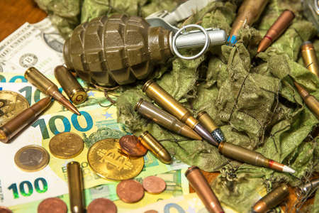 Support for Ukraine. War in Ukraine. Euro coins and banknotes and cartridges of different caliber. Sale of weapons. Ammunition for warの写真素材