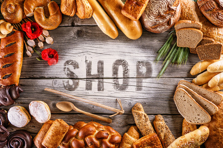breads, pastries, christmas cake on wooden background with letters, picture for bakery or shopの写真素材