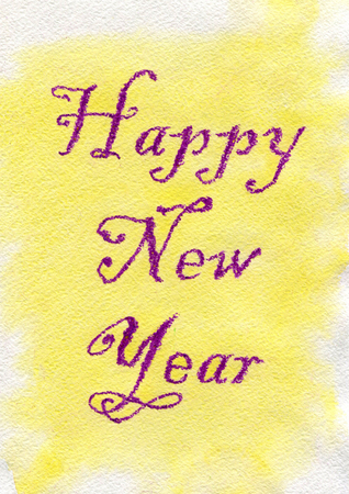 New Year. Violet lettering made by wax crayons on the yellow watercolor background.の写真素材