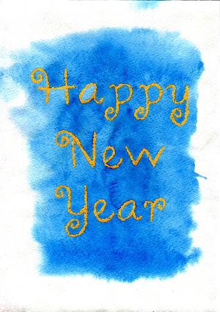 New Year. Yellow lettering made by wax crayons on the blue watercolor background.の写真素材