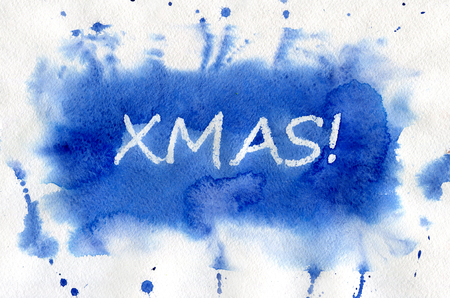 XMAS. White lettering made by wax crayons on the blue watercolor background.の写真素材